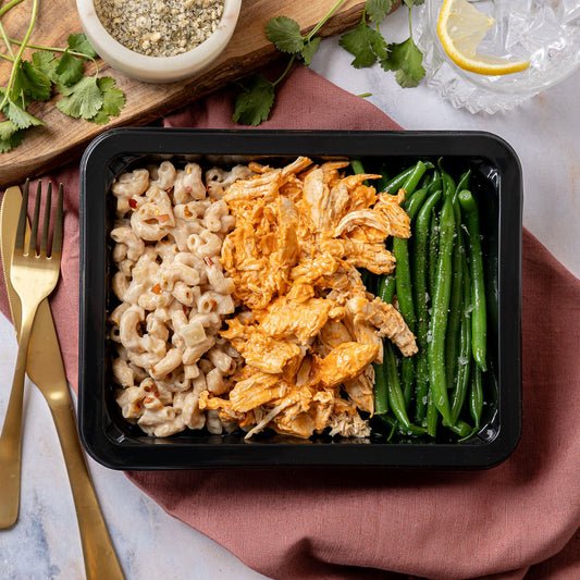 Buffalo Chicken & Mac N Cheese - Tender shredded chicken breast tossed in spicy buffalo sauce, creamy mac n cheese, and green beans